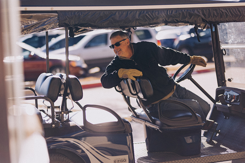 Man backing up a golf cart